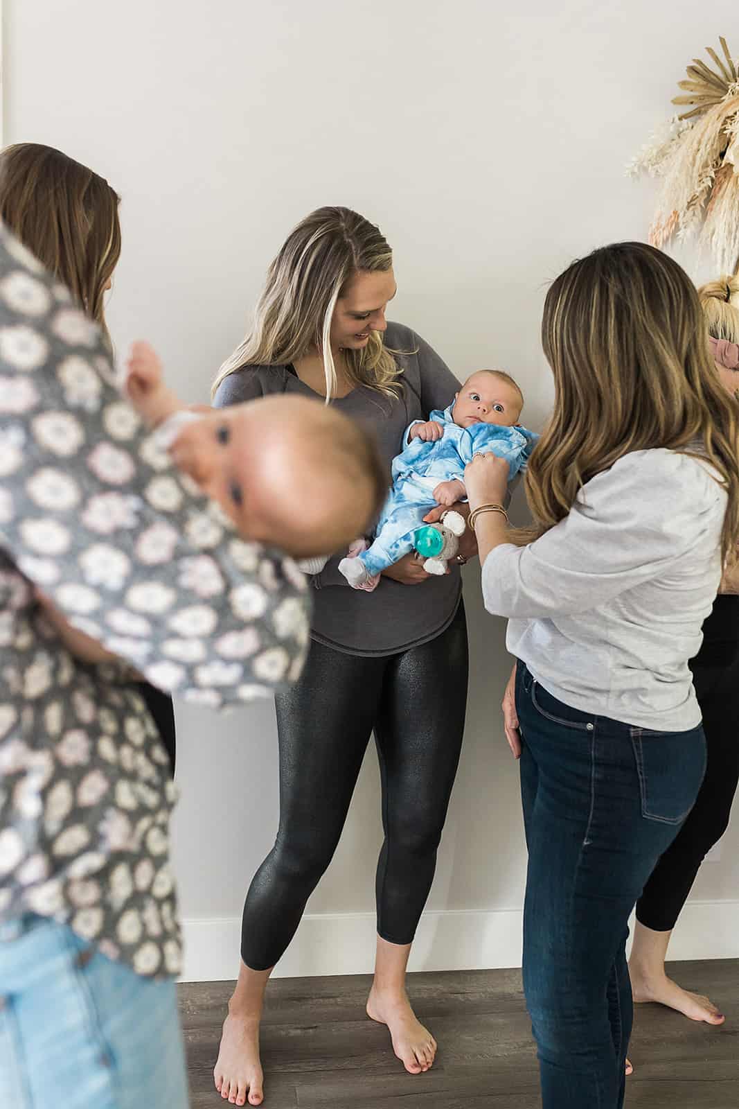 Moms holding their newborns at the New Mom School