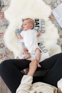 Woman Sitting In Front Of Baby