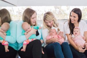 three mothers with their new borns on their laps