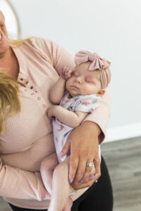 A Baby being held in a women's arms