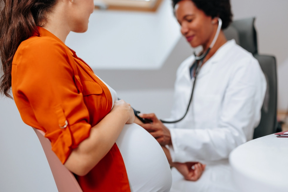 OB-GYN consulting with pregnant patient in Greenville, SC office.