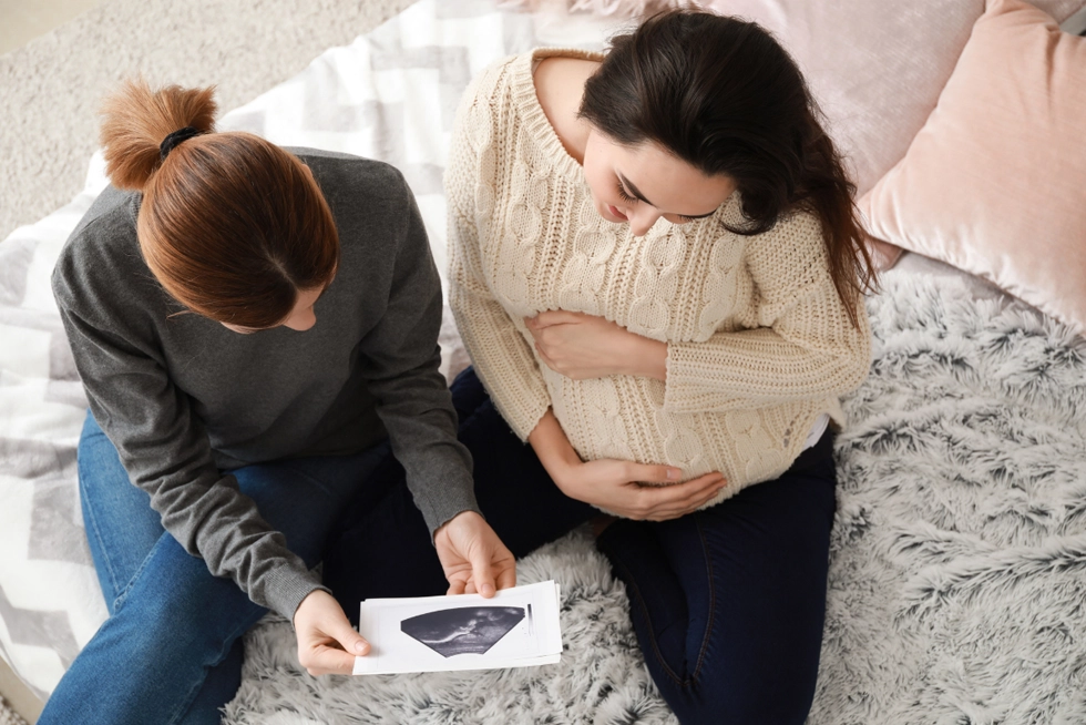 Midwife supporting a pregnant woman with prenatal care in Greenville, SC.