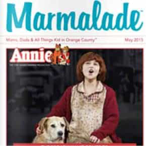 Marmalade magazine cover featuring Annie musical scene with young girl and dog.
