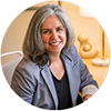 Dr. Sonya Rasminsky – New Mom School Testimonial Headshot of Dr. Sonya Rasminsky, seated and smiling, featured in a testimonial for New Mom School.
