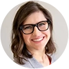 Dr. Zhanna Pinkus – New Mom School Endorsement Headshot of Dr. Zhanna Pinkus, smiling and wearing glasses, featured in a testimonial or endorsement for New Mom School.