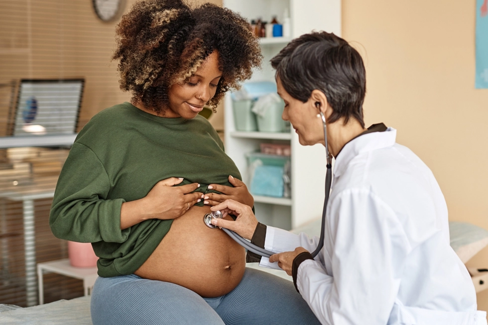 Pregnant woman receiving prenatal care from an OB-GYN during a pregnancy checkup in Katy, Texas.