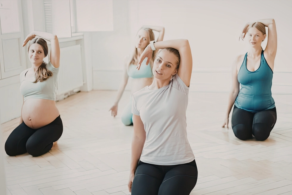 Top-Rated Prenatal Fitness Classes in Greater Heights TX Pregnant women participating in a prenatal fitness and stretching class in Greater Heights, Texas.