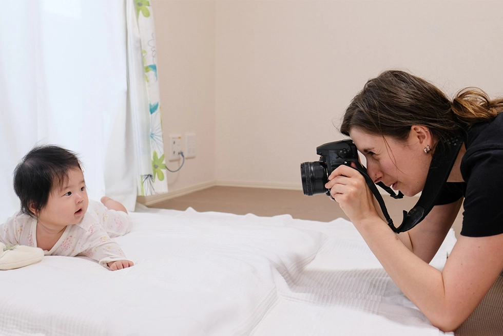 Professional newborn photographer taking photos of a baby during an in-home newborn photography session in Aliso Viejo, California.