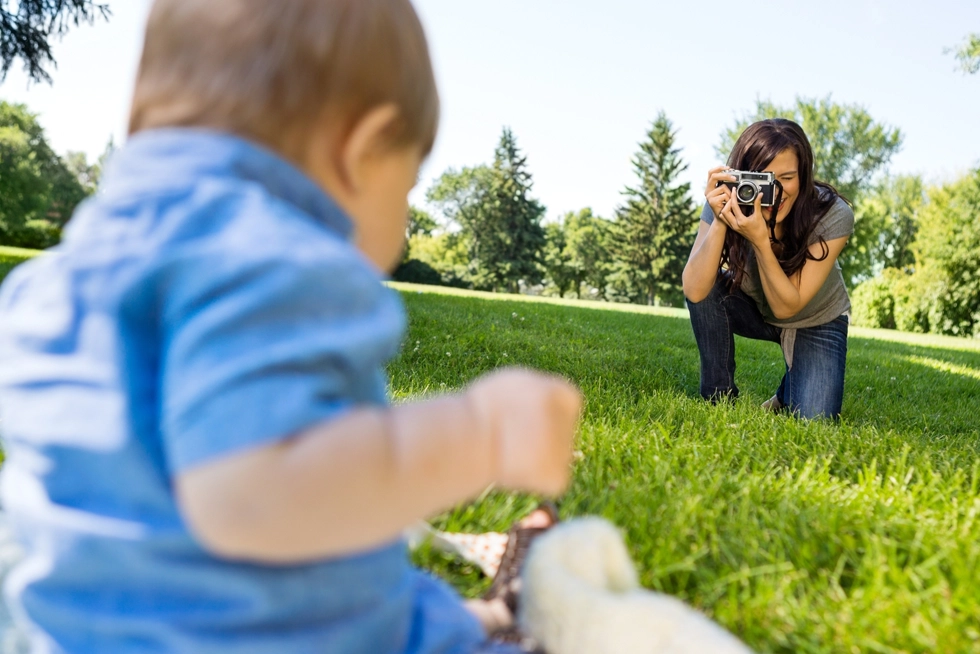 Professional newborn photographer taking outdoor baby portraits during a family photography session in St. Louis, Missouri.